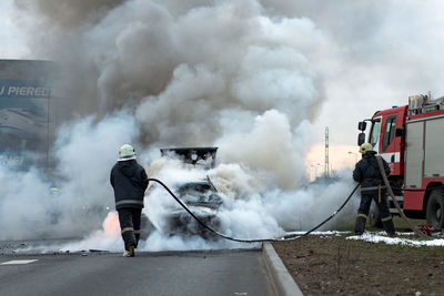 Rear view of man standing against smoke