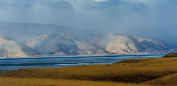 Scenic view of lake and mountains against sky