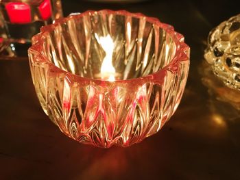 Close-up of illuminated tea light candle on table