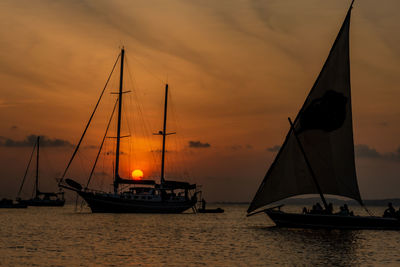 A yacht with a sun set in the background