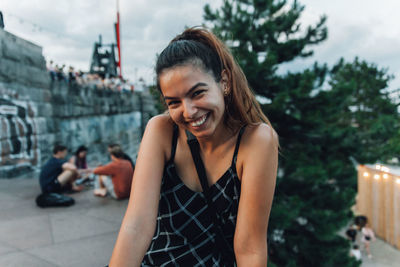 Portrait of smiling woman in city