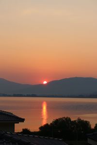 Scenic view of lake against romantic sky at sunset