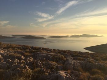 Scenic view of sea against sky seen from cliff during sunset