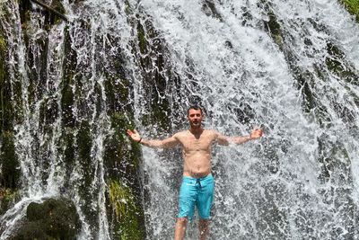 Full length of shirtless man in water