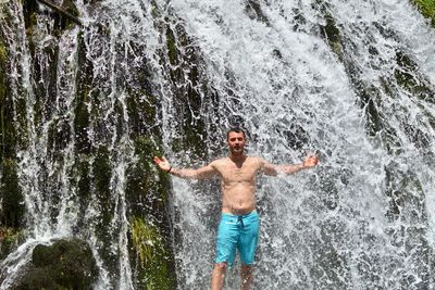 Full length of shirtless man in water