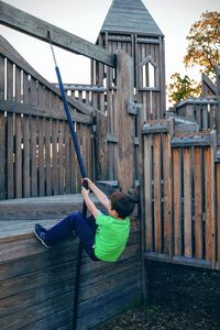 Boy climbing on jungle gym at park