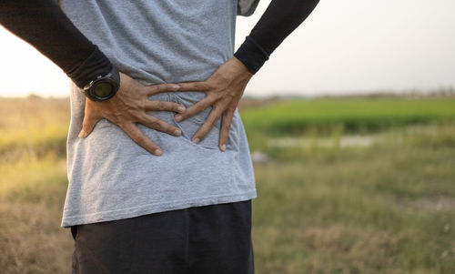 Midsection of man standing on field