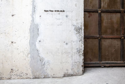 Full frame shot of weathered wall with closed door