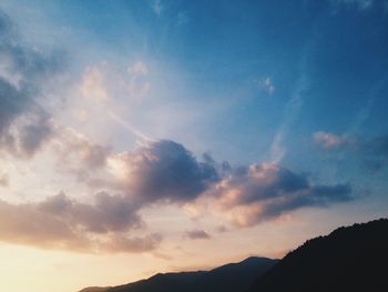 Scenic view of mountains against cloudy sky