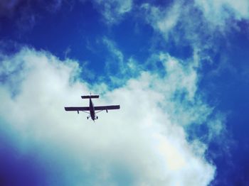 Low angle view of airplane against sky