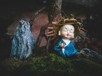 Close-up of buddha statue against trees