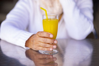 Midsection of man drinking glass