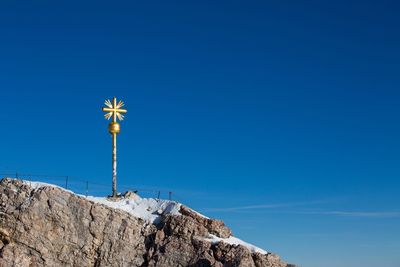 Low angle view of street light against clear blue sky