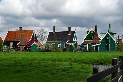 Houses on field against sky