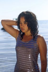 Close-up of wet woman standing at beach