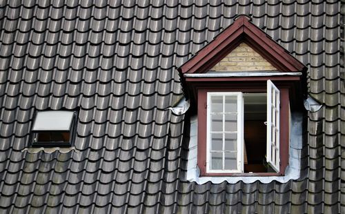 Low angle view of open window on roof of building