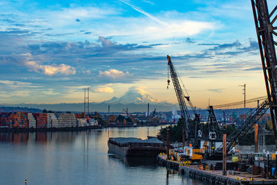 Sailboats at harbor against sky during sunset
