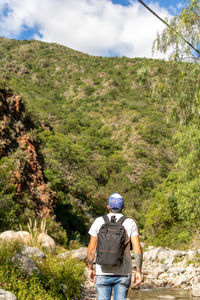 Rear view of a man walking on mountain