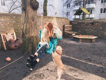 Woman on swing with dog