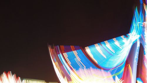 Low angle view of light trails at night