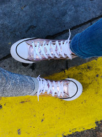 Low section of people standing on road with marking