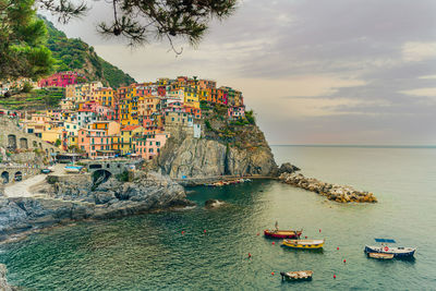 Scenic view of sea and buildings against sky