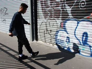 Full length of man on wall in city