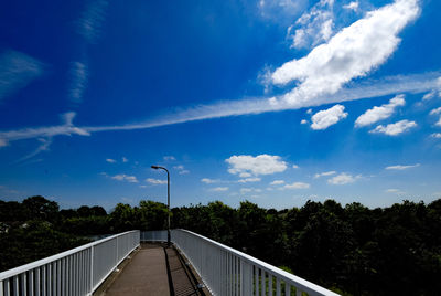 Footbridge against blue sky
