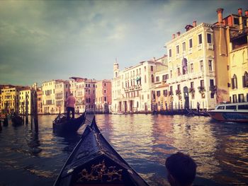 Boats in canal along buildings