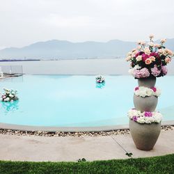 Scenic view of swimming pool by sea against sky