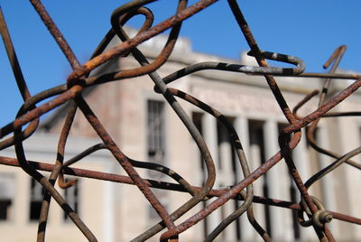 Low angle view of barbed wire against sky