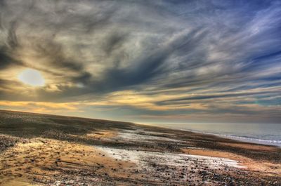 Scenic view of sea against cloudy sky