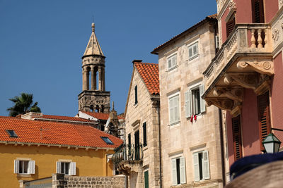 Buildings in city against clear sky