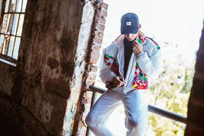 Man standing against wall