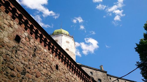 Low angle view of historical building against cloudy sky