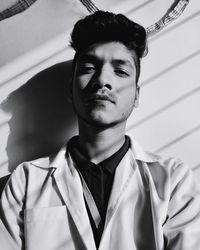 Portrait of young man standing indoors