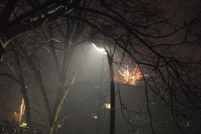 Low angle view of illuminated street light at night