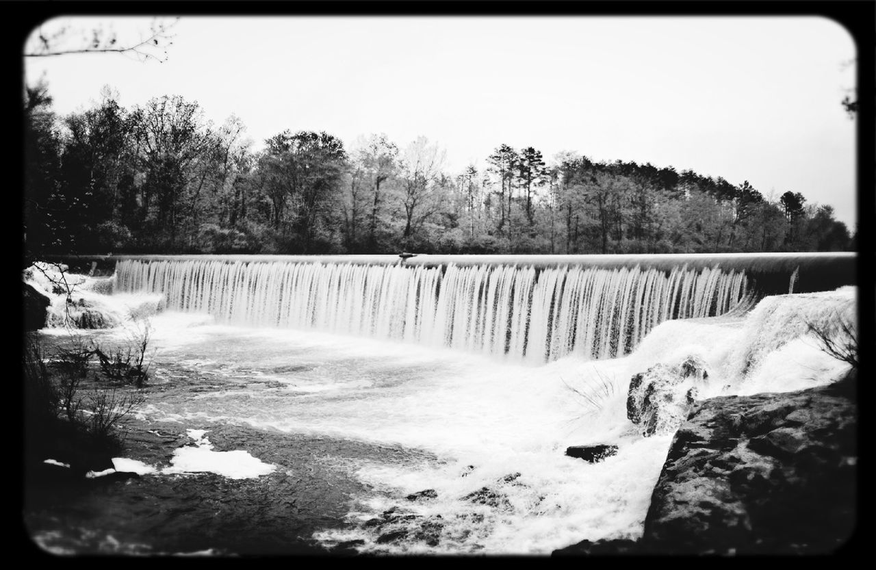 water, tree, transfer print, scenics, beauty in nature, tranquil scene, tranquility, nature, winter, auto post production filter, snow, cold temperature, clear sky, river, flowing water, rock - object, forest, flowing, season, non-urban scene