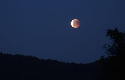 Low angle view of moon against sky at night