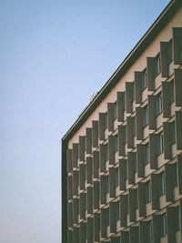 Low angle view of building against clear blue sky