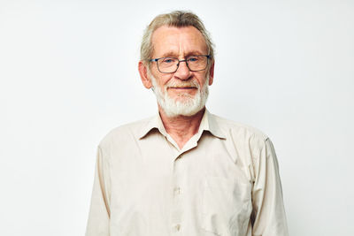 Portrait of man standing against white background