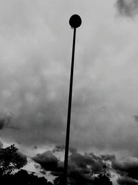 Low angle view of street light against cloudy sky