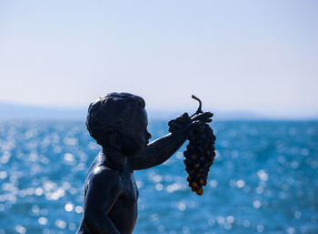 Statue of sea against clear sky