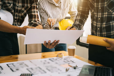 Midsection of business colleagues working in office