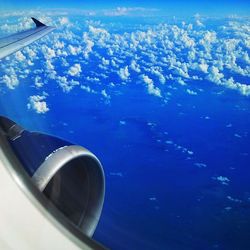 Cropped image of airplane wing over landscape