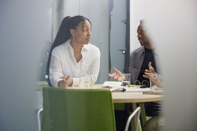 Man and woman talking during business meeting