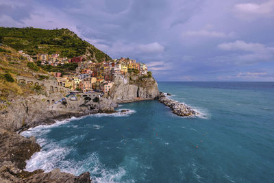 Scenic view of sea and buildings against sky