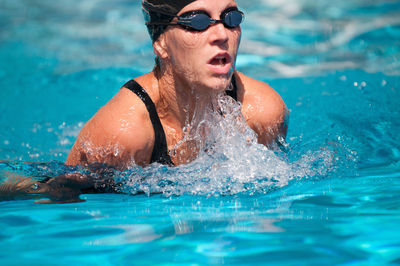 High angle view of mid adult woman swimming in pool