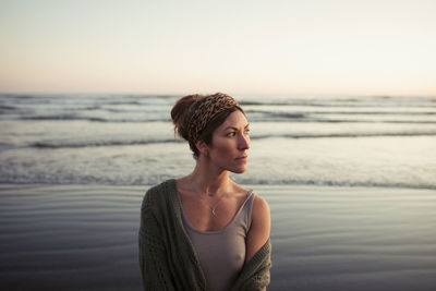 Beautiful woman on long beach at sunset in tofino