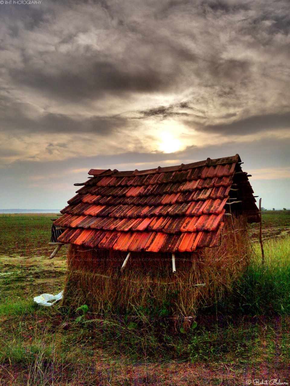 sky, built structure, building exterior, architecture, cloud - sky, house, grass, cloudy, field, barn, rural scene, cloud, roof, sunset, landscape, outdoors, no people, nature, sunlight, residential structure